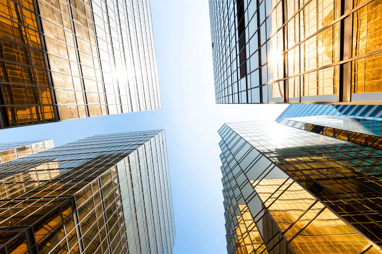 Looking modern office building from below.