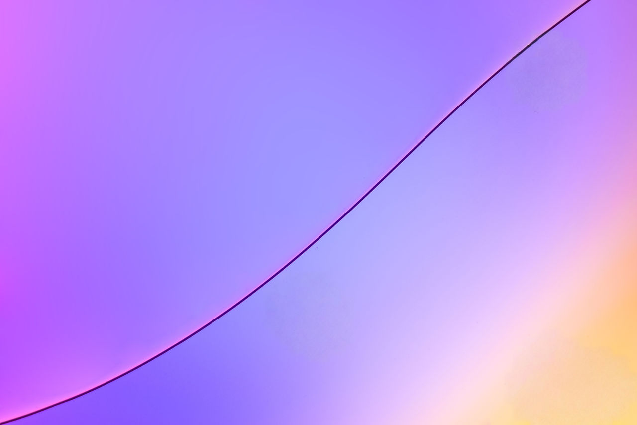 Top view movement of oil bubbles in the liquid. Oil surface multicolored background. Fantastic structure of colorful bubbles. Colorful artistic image of oil drop floating on the water